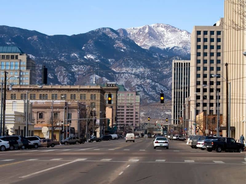 Downtown Colorado Springs with Pikes Peak in the background representing professional land surveying services, property surveys, and land development planning